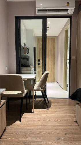 a dining room with a table and two chairs at Once Pattaya Seaview Condo in Pattaya Central