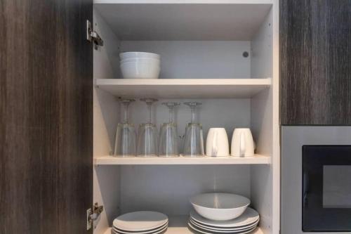 a kitchen pantry with dishes and utensils at Avery 2 Studio @Embassy Gardens in Accra