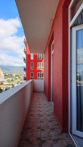 a balcony of a building with a red wall at Kakha in Tbilisi City