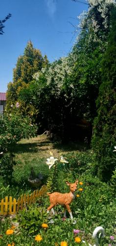 a small toy deer in a field of flowers at Уютный Дворик Чолпон-Ата in Cholpon-Ata