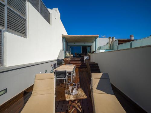 a balcony with tables and chairs on a building at Penthouse with Private Swimming Pool in Melenara