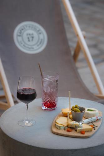 a glass of wine and a plate of cheese and fruit at Le Saint-Nicolas in La Rochelle