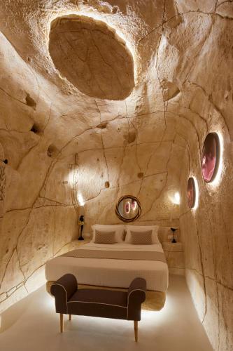 a bedroom with a bed in a stone cave at Artion Luxe Apartment in Vourvoúlos