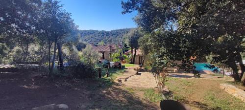 a view of a yard with a house and a pool at El Racó dels Mussols 1 in Canet de Adri