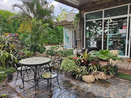 a table and chairs in front of a store at The Creek Resort in Ban Rai