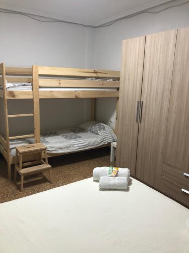 a room with two bunk beds and a bed at Cozy room in a shared apartment near the See Port Valencia in Valencia