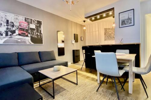 un salon avec un canapé bleu et une table dans l'établissement Bel appart à Nogent-sur-Marne, à Nogent-sur-Marne