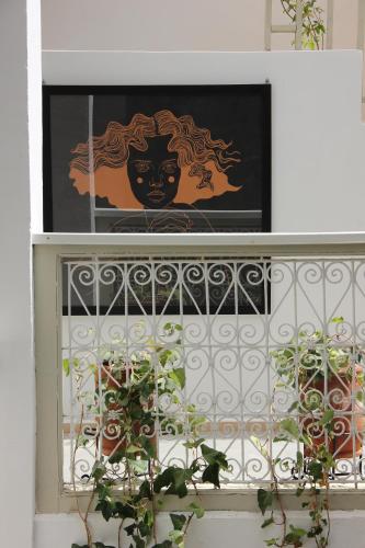 a window with a painting of a woman with hair at Riad Dar Nael in Marrakech