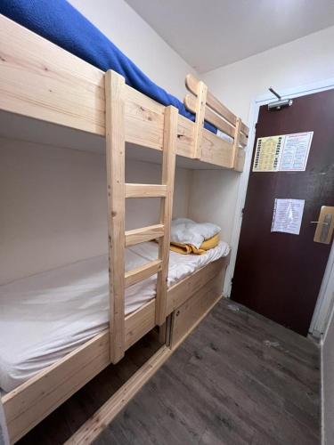 a couple of bunk beds in a room at Joli studio au pied des pistes in Villard-de-Lans