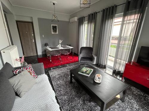 a living room with a couch and a table at Beautiful apartment next to metro station in Athens