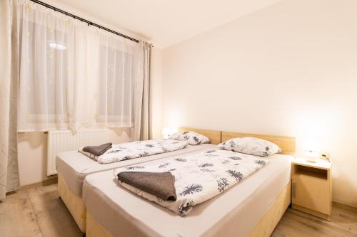Postel nebo postele na pokoji v ubytování Szelidi Apartmanok