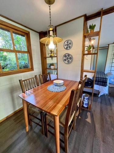 a dining room with a wooden table and chairs at Cabana Mirim Estalagem Rural in Gramado