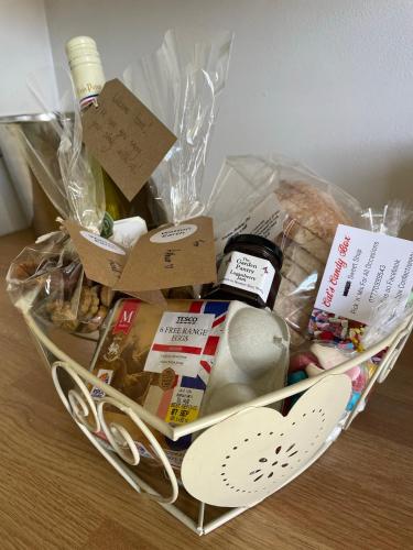 a basket filled with food and other items on a table at Hidden gem in heart of Breckland in Watton