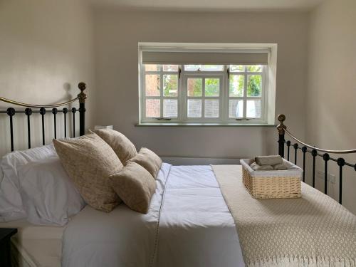 a bedroom with a bed with pillows and a window at Hidden gem in heart of Breckland in Watton