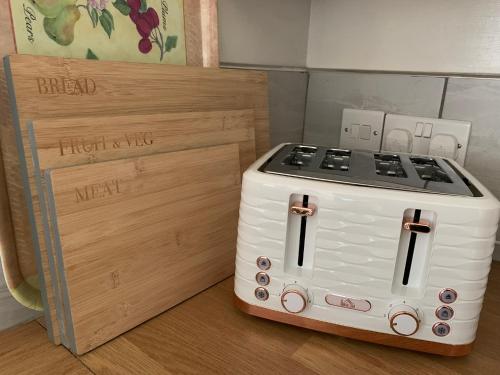 a pretend stove is next to a wooden box at Hidden gem in heart of Breckland in Watton