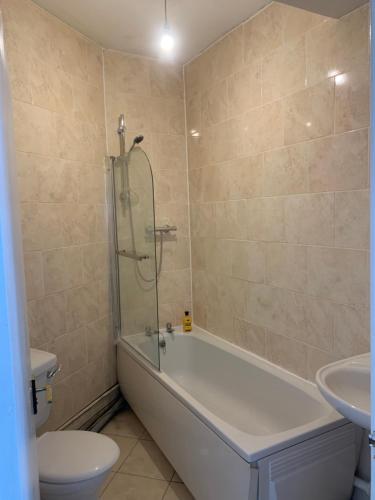 ein Badezimmer mit einer Badewanne, einem WC und einem Waschbecken in der Unterkunft New 2 bedroom Apartment in Greater Manchester in Ashton under Lyne