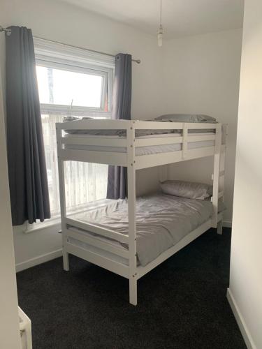 a white bunk bed in a room with a window at New 2 bedroom Apartment in Greater Manchester in Ashton under Lyne
