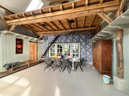 a dining room with a table and chairs at Pleisterplaats Schöppert B&B in Neede