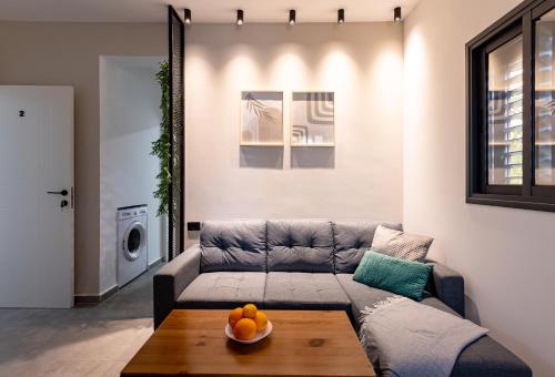 a living room with a couch and a table at Luxury Central Old Town Apartment in Beer Sheva