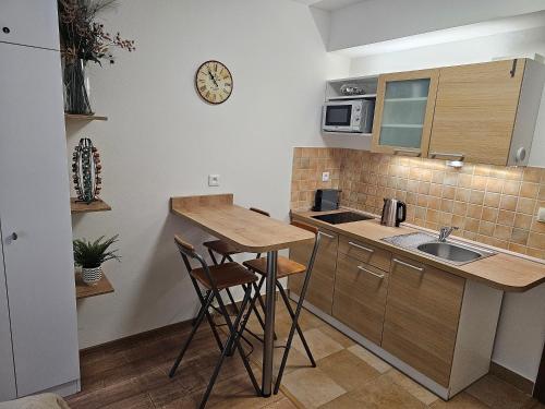a small kitchen with a sink and a counter at Apartmánový dom Kamzík apt. 16 in Donovaly