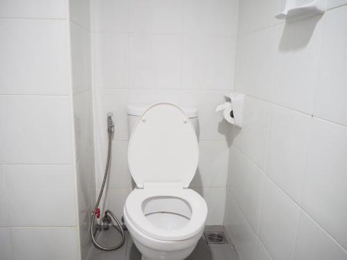 a white toilet in a bathroom with a shower at NANA BEST INN HOTEL in Makkasan