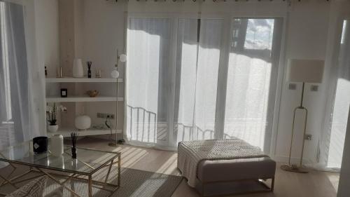 - un salon avec une table en verre et une chaise dans l'établissement Le berlier 13, à Paris