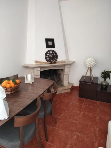 a dining room with a table and a fireplace at Casa do Rio By Viva a Vida - Alojamentos & Hotels in Constância