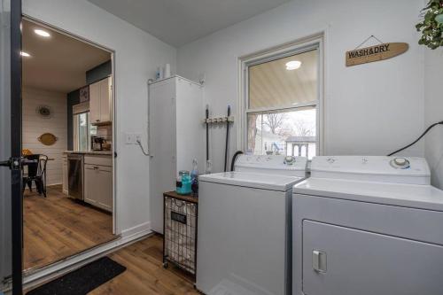 a white laundry room with two washes and a window at Close to airport* Pets*Fenced yard*A/C & Fast WIFI in Cleveland