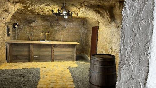 a bathroom with a sink and a barrel at Gîte troglodyte 2 personnes in Azay-le-Rideau