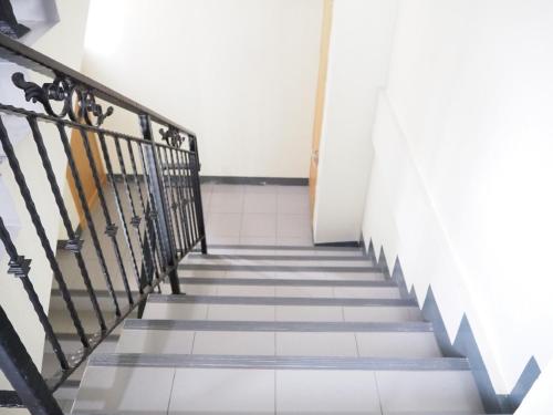 a staircase in a building with a stair railing at NANA BEST INN HOTEL in Makkasan
