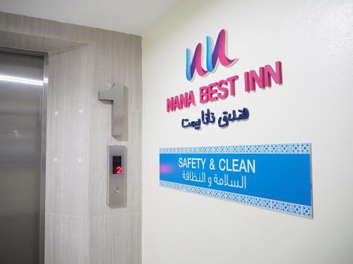 a sign on the wall of a building with a sign at NANA BEST INN HOTEL in Makkasan