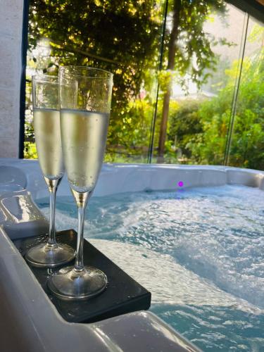 - deux verres de champagne sur un plateau à côté de la piscine dans l'établissement Feifei's Home & Spa - Luxe 10 min Paris, à Asnières-sur-Seine