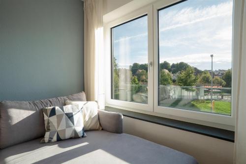 Postel nebo postele na pokoji v ubytování VOYAGE Stadtoase am Fluss I Zentral I freier Parkplatz I Wifi I Netflix I Aufzug