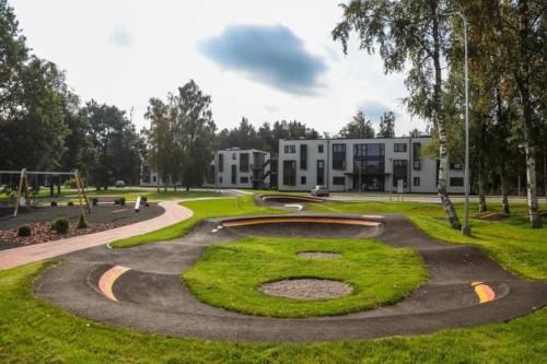 a park with a large sign in the grass at Nice apartment with a balcony by the sea. in Ķesterciems