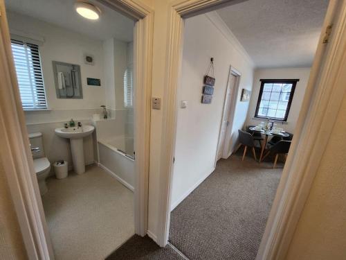 a bathroom with a tub and a sink and a toilet at 10 Ladyknowe court in Moffat