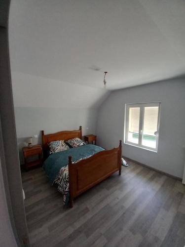 a bedroom with a bed in the corner of a room at maison du chemin de fer in Grandcourt