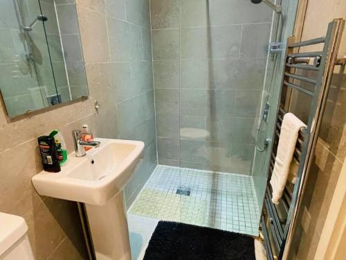 a bathroom with a sink and a shower at Cosy ground floor apartment in Huntingdon
