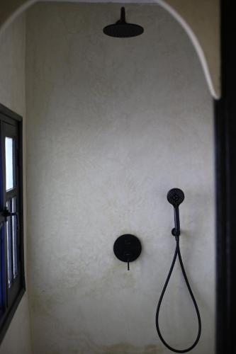 a wall with a blow dryer on a wall at Kasbah des cyprès in Skoura