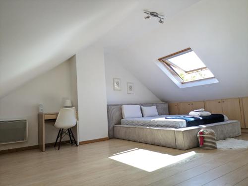 a bedroom with a bed and a skylight at Le Cocon Céleste à Longjumeau in Longjumeau