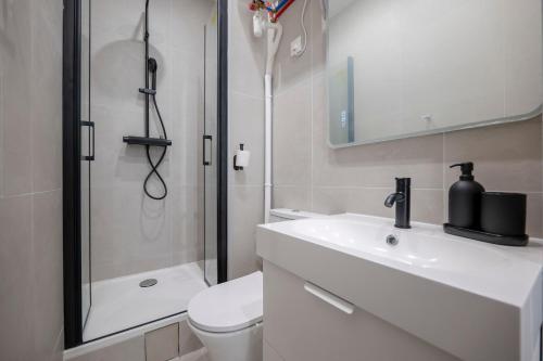 a bathroom with a toilet and a sink and a shower at Renovated Studio walking distance to Paris in Montrouge