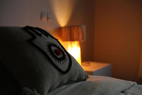 a pillow with an eye on it sitting on a bed at Kasbah des cyprès in Skoura