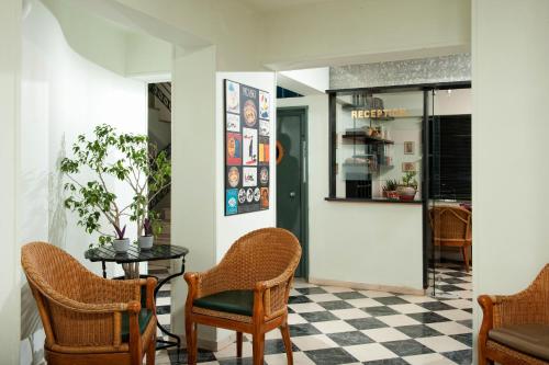 a room with a table and chairs and a checkered floor at Andromeda Apartments & Studios in Hersonissos