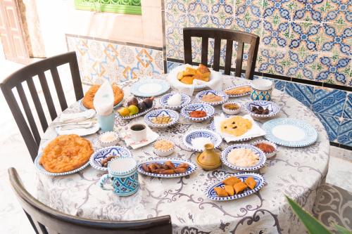 a table with plates of food on it at Dar Badiaa in Sousse