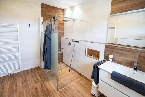a bathroom with a sink and a mirror at Ferienresidenz Hunsrück Hochwald in Mörschied