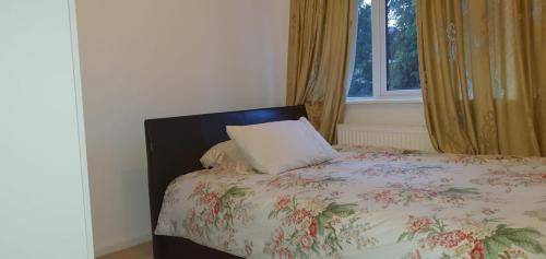 a bedroom with a bed with a pillow and a window at 2-Bed House in Poole in Parkstone
