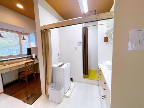 a bathroom with a sink and a desk at Minowa airbnb in Yubari