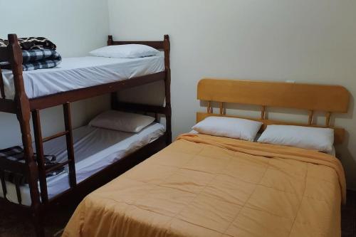 a bedroom with two bunk beds and a bed at Oberon in Curitiba