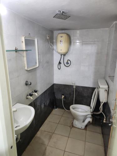 a bathroom with a toilet and a sink at Sea doll 7th floor with Sea view in Visakhapatnam