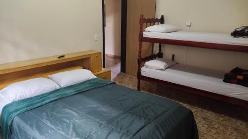 a bedroom with two bunk beds in a room at Oberon in Curitiba