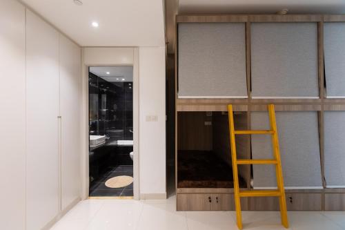 a yellow ladder in a bathroom with a sink at Hostel InterCube in Dubai